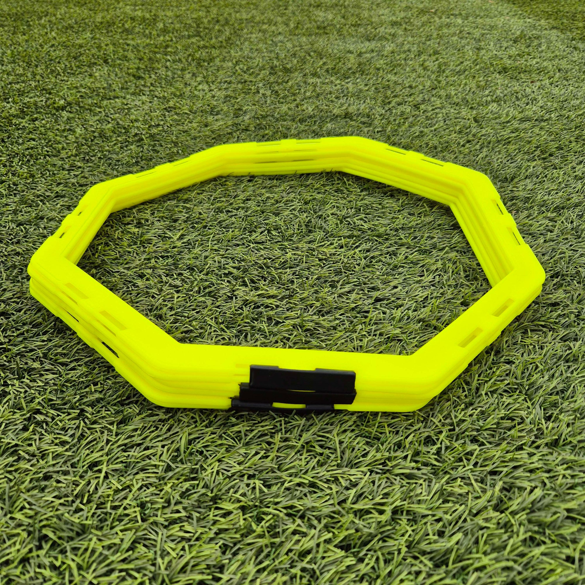 Yellow hex training disc on grass
