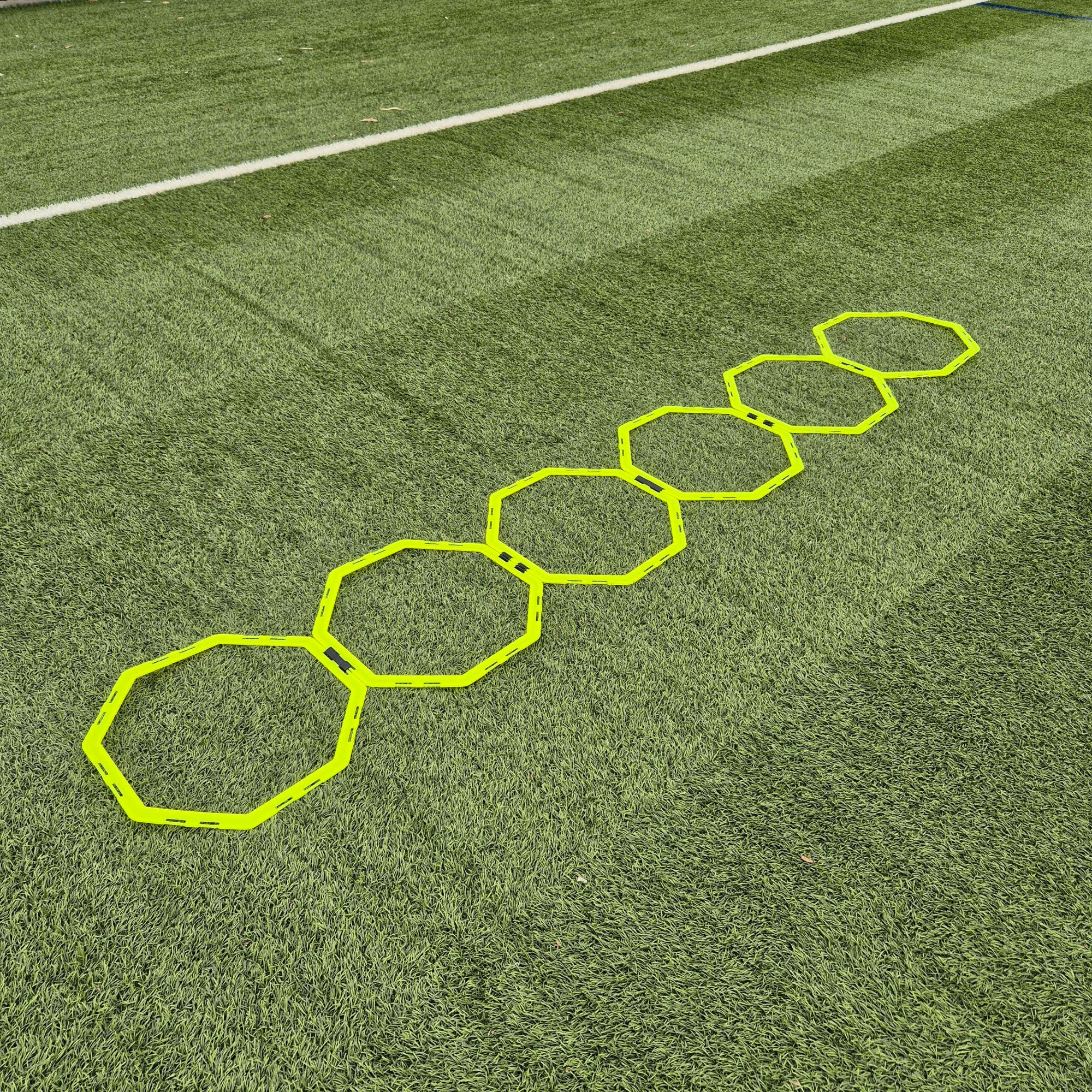 Hexagonal training markers on a grass field