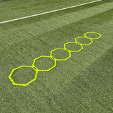 Hexagonal training markers on a grass field