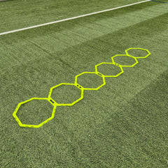 Hexagonal training markers on a grass field